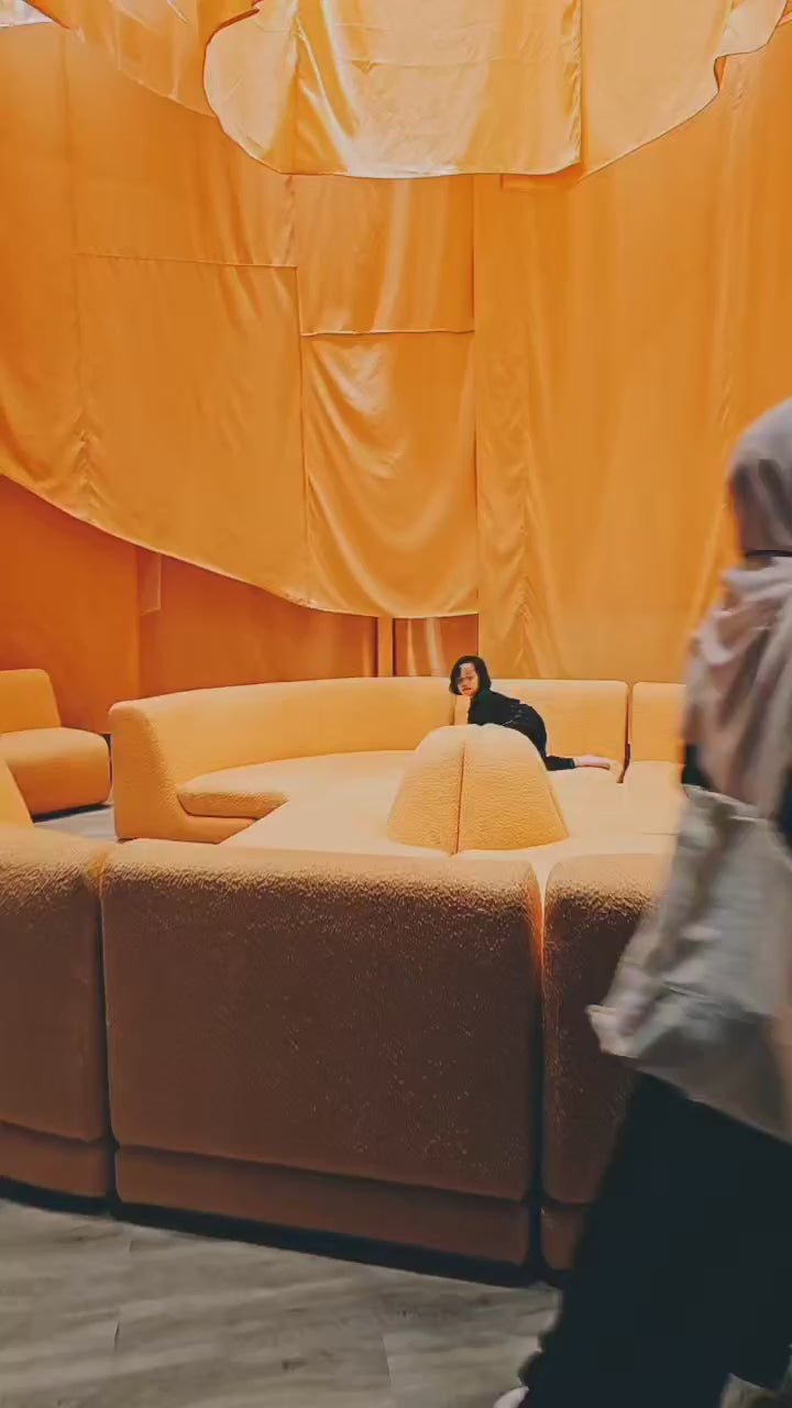 Visitor playing on our Rangkul Modular Sofa by Beranda Living